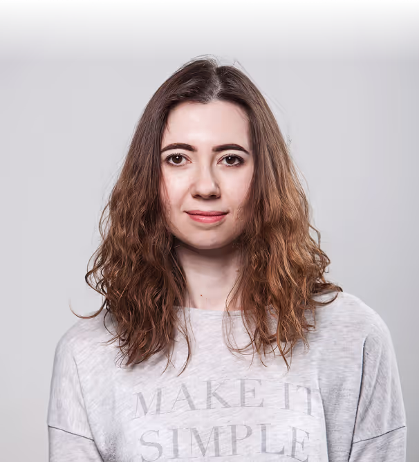 Natalia Donchenko in a grey Make It Simple sweatshirt against a grey studio wall